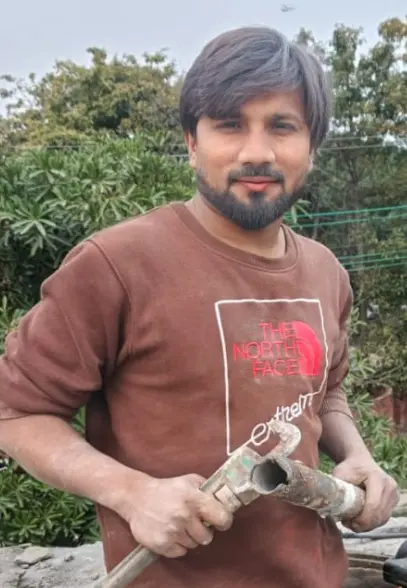 Zubair holding a pipe wrench